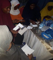 Women registering at a JCC community session on gender-based violence prevention
